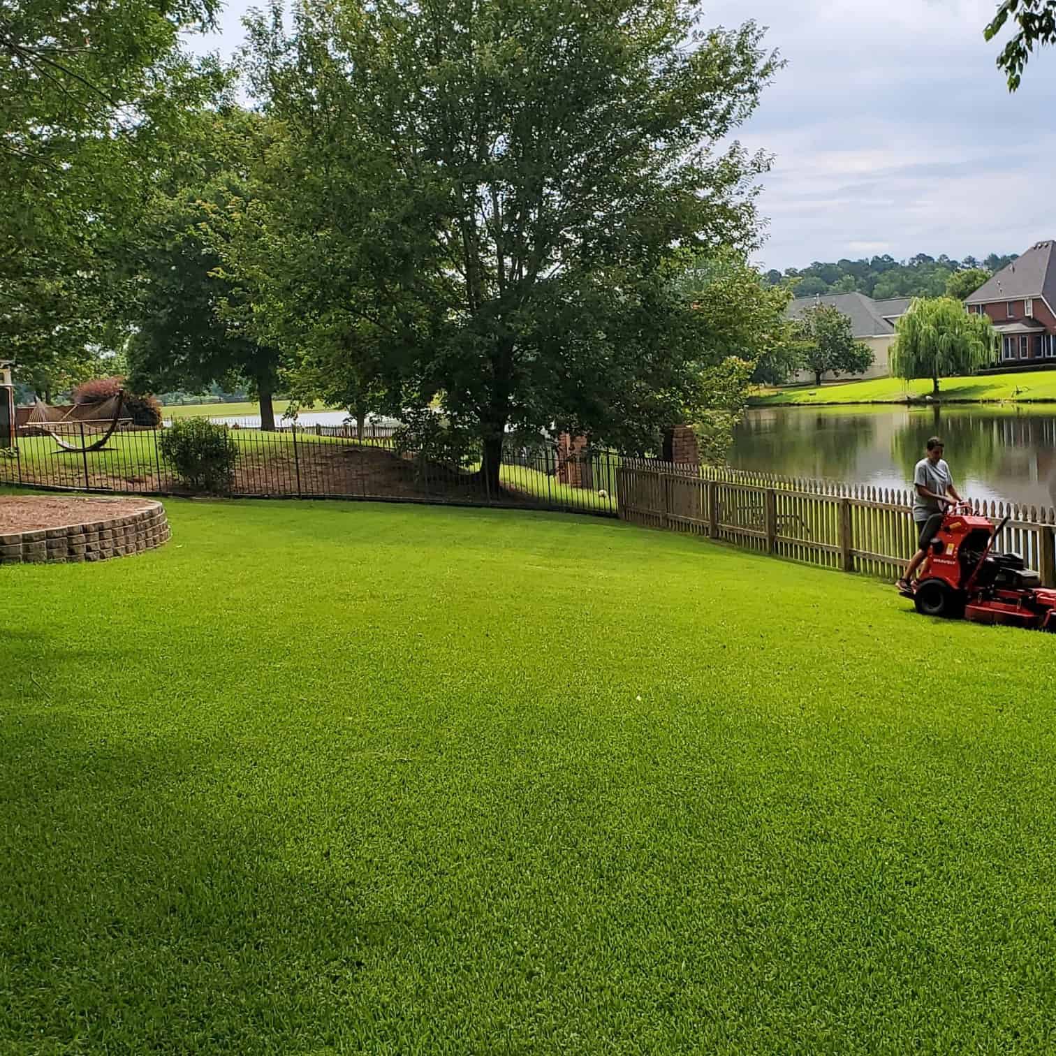 man mowing lawn on riding mower